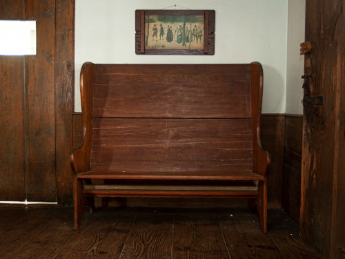 Wood settle in Dwight Derby House