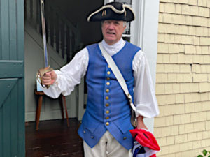 Man dressed in patriot costume in front of Dwight Derby House